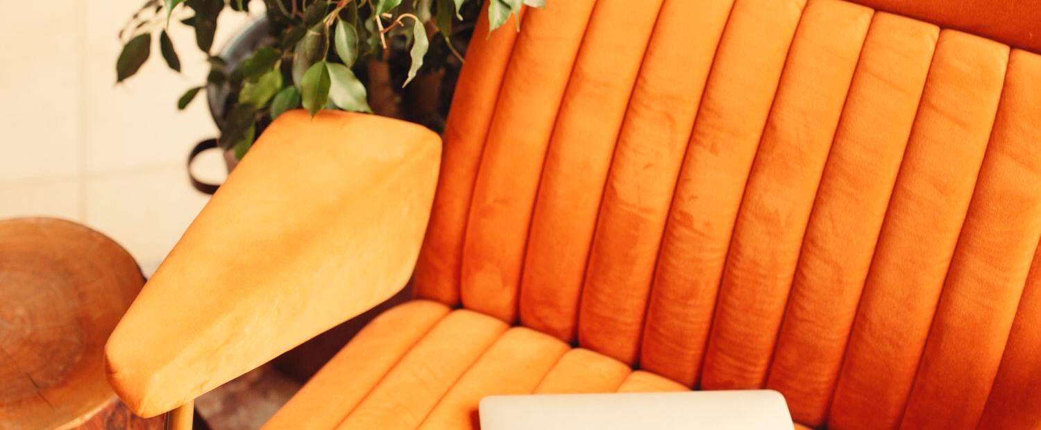 Orange armchair with laptop