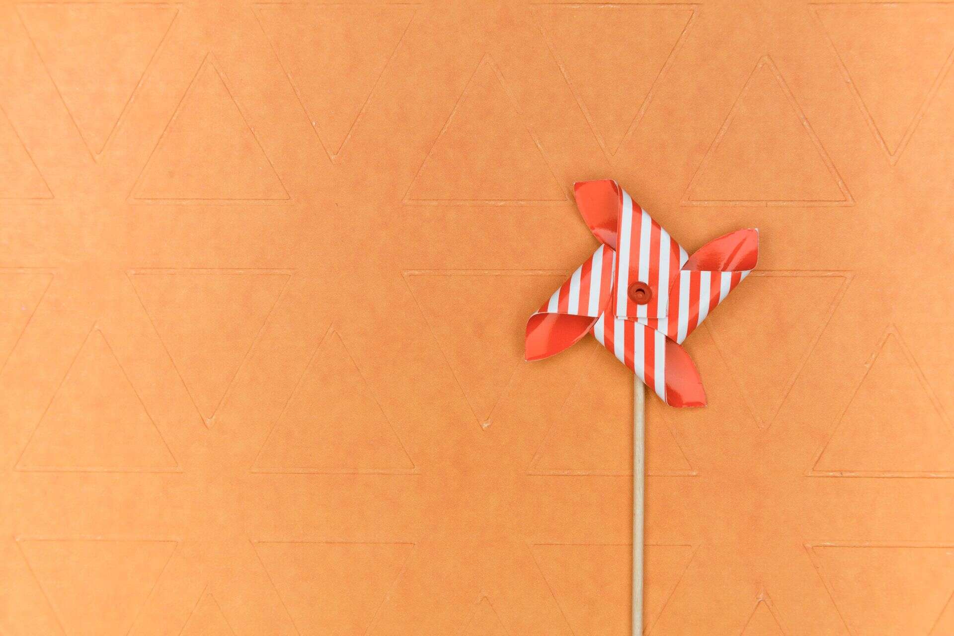 Striped pinwheel on orange background